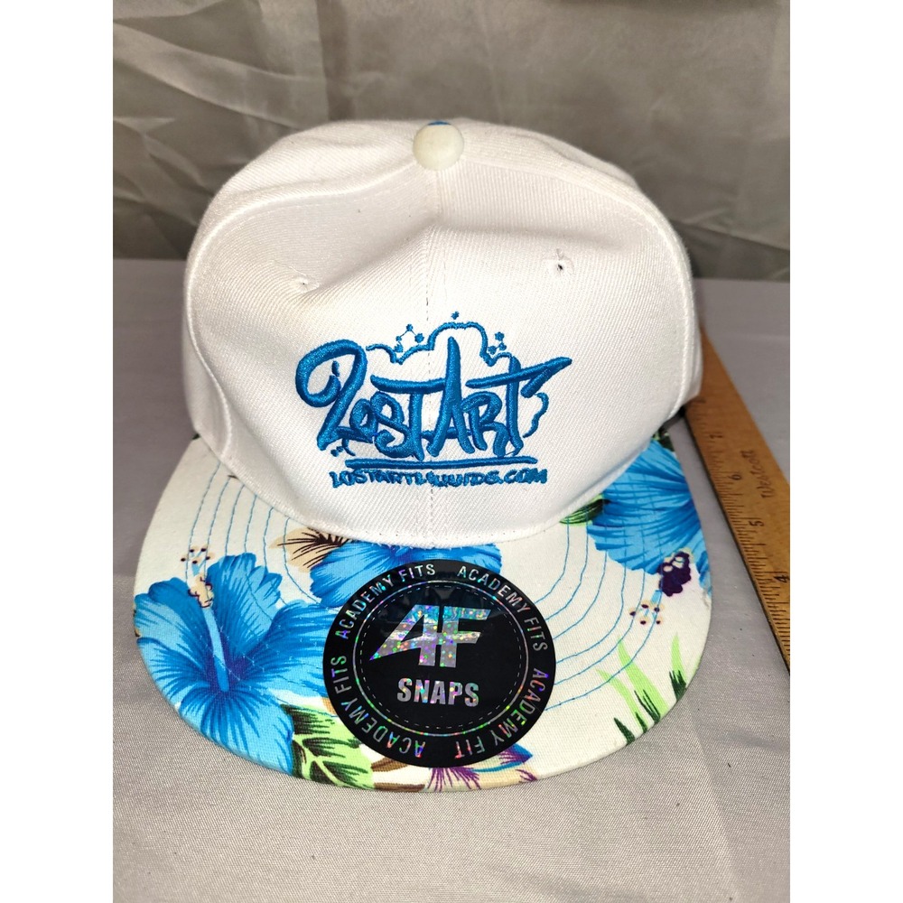 White snapback hat featuring a blue embroidered Lost Art logo